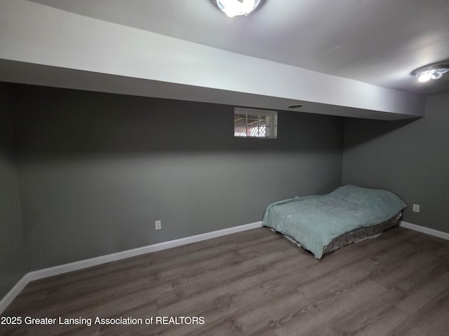 bedroom with wood finished floors and baseboards