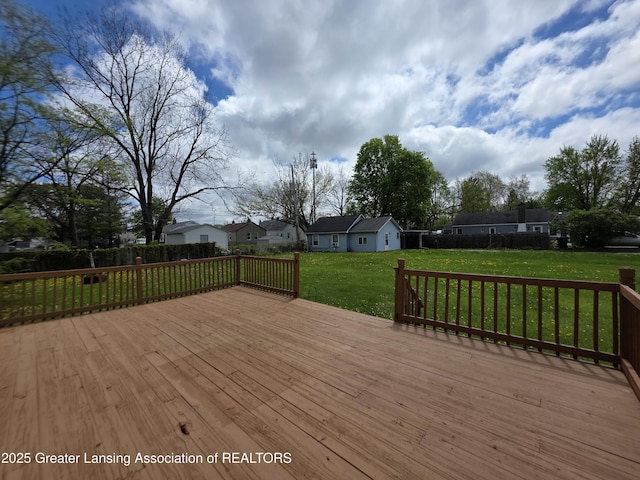 deck featuring a lawn and a residential view