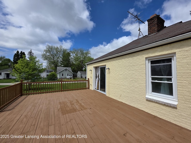 wooden terrace with a lawn