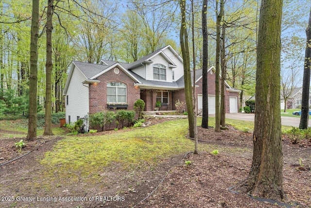 traditional-style home with driveway, brick siding, a porch, a garage, and a front yard