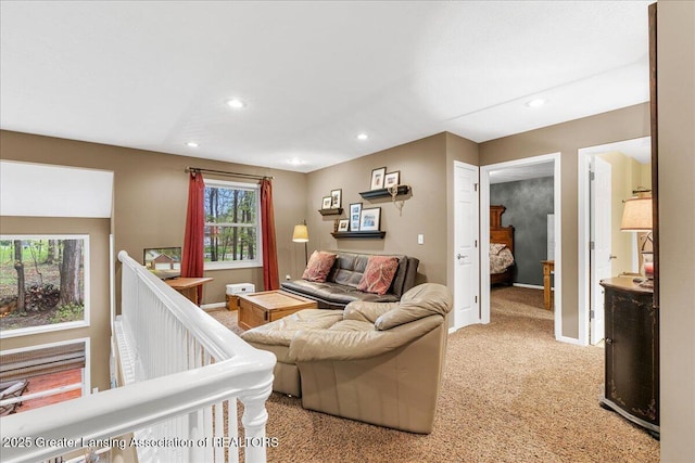 living room featuring light carpet, recessed lighting, and baseboards