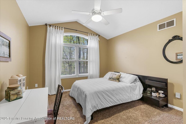 carpeted bedroom with lofted ceiling, baseboards, and a ceiling fan
