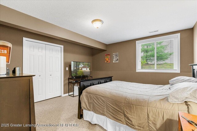 bedroom with light colored carpet and a closet