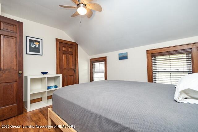 bedroom featuring vaulted ceiling, wood finished floors, and ceiling fan