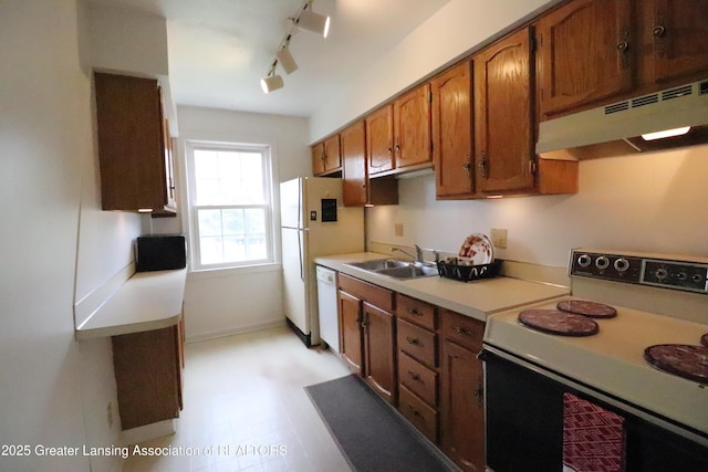 kitchen with electric range, under cabinet range hood, a sink, dishwasher, and light countertops
