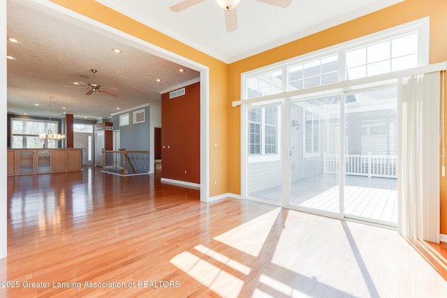 empty room with ceiling fan, crown molding, wood finished floors, recessed lighting, and baseboards