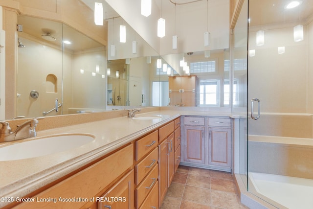 full bath with a stall shower, double vanity, and tile patterned floors