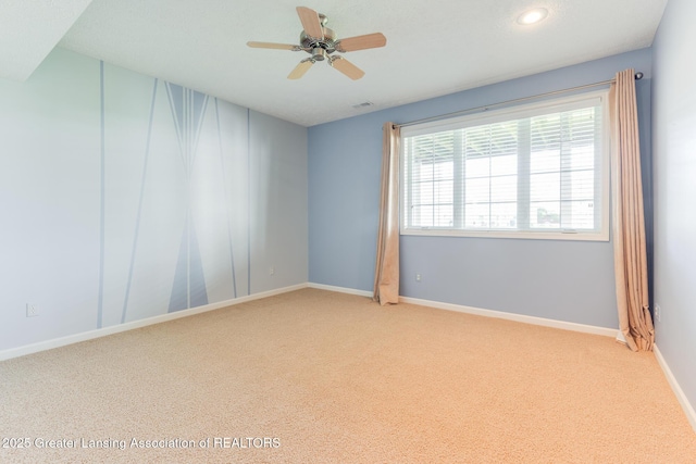 spare room with ceiling fan, light carpet, baseboards, and recessed lighting