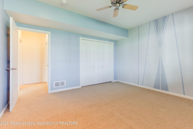 unfurnished bedroom featuring carpet, baseboards, and a closet