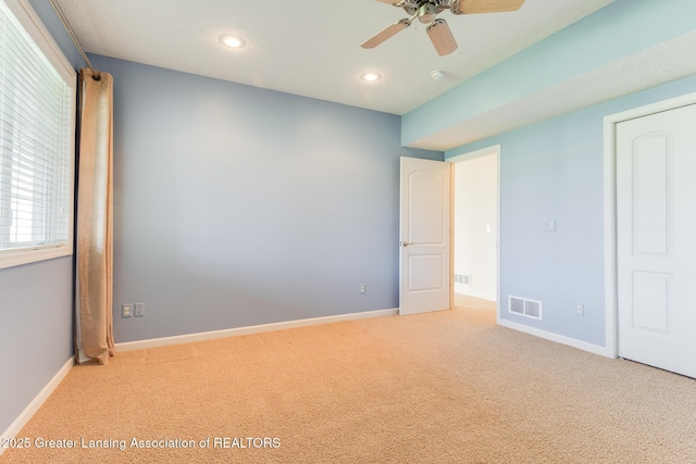 unfurnished bedroom featuring light colored carpet, recessed lighting, baseboards, and a ceiling fan