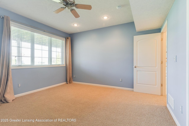spare room with carpet flooring, recessed lighting, a ceiling fan, and baseboards