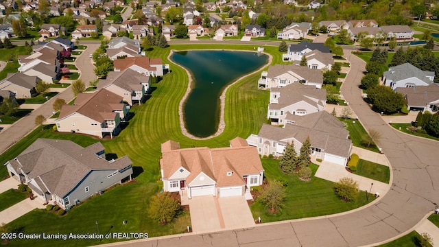 aerial view of residential area featuring a large body of water