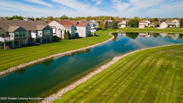 aerial view of residential area featuring a nearby body of water