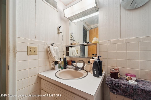 bathroom featuring tile walls, tasteful backsplash, and vanity