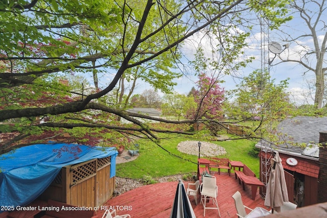 view of green lawn with a deck