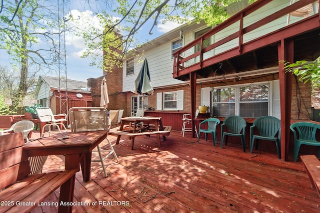 wooden deck featuring outdoor dining space