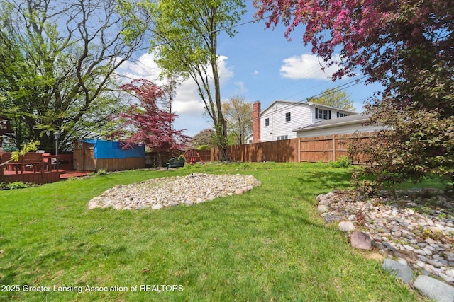 view of yard with a wooden deck and a hot tub