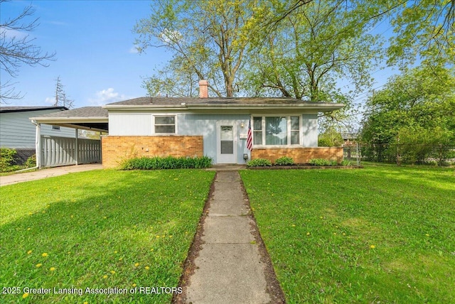 view of front of property with brick siding, an attached carport, concrete driveway, and a chimney