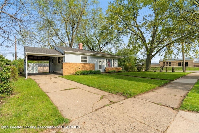 view of front facade featuring a front lawn, an attached carport, a chimney, driveway, and brick siding