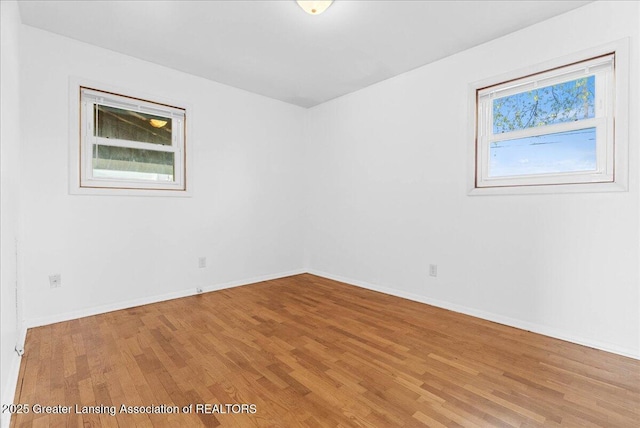 empty room with light wood-style floors and baseboards