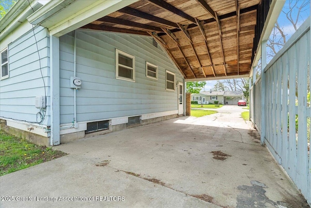 view of side of home with a carport