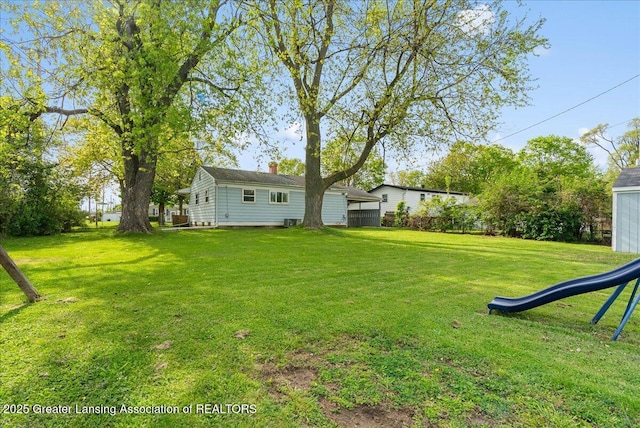 view of grassy yard with a playground