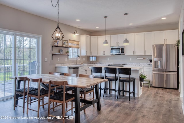 dining area featuring recessed lighting and wood finished floors