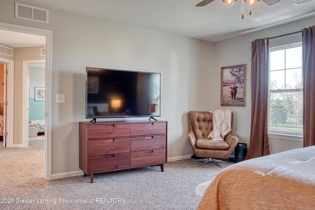 bedroom featuring carpet, a textured ceiling, a ceiling fan, and baseboards