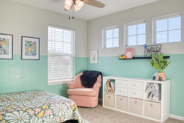 bedroom featuring multiple windows, carpet, and a ceiling fan