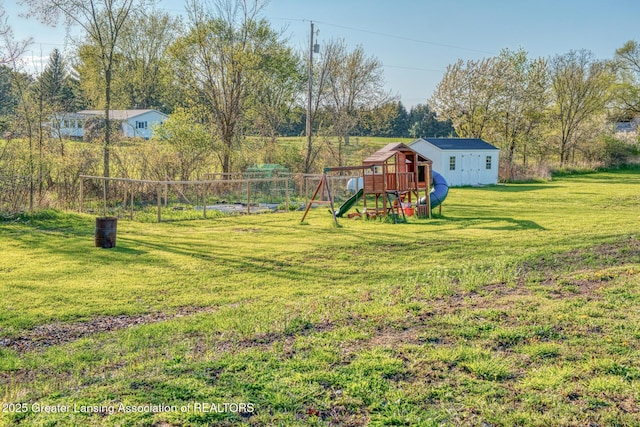 view of yard featuring a playground and an outdoor structure