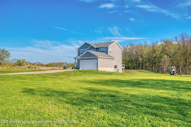 view of side of home with driveway, a lawn, and an attached garage