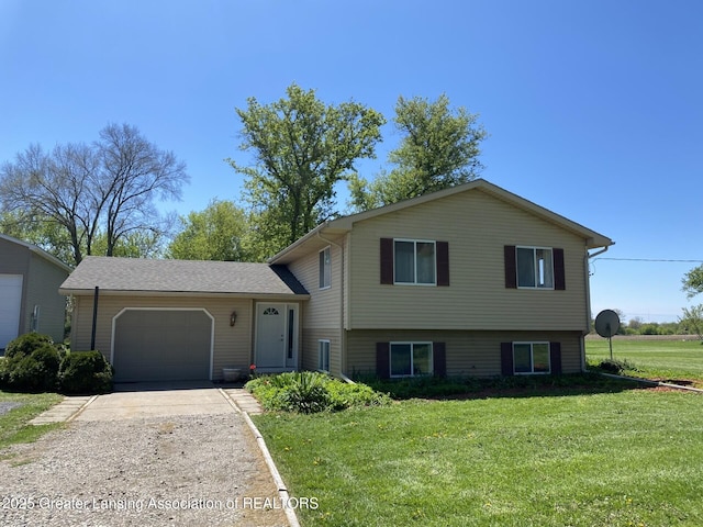 split level home featuring an attached garage, concrete driveway, and a front yard
