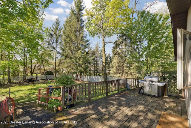 933 W Northrup St, Lansing, MI 48911 - wooden deck with a grill, a fenced backyard, and view of wooded area