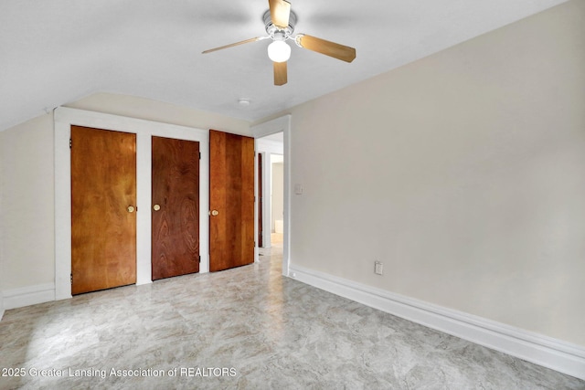 unfurnished bedroom featuring multiple closets, baseboards, and ceiling fan
