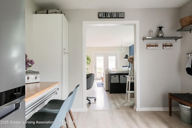 office space featuring light wood-style flooring and baseboards