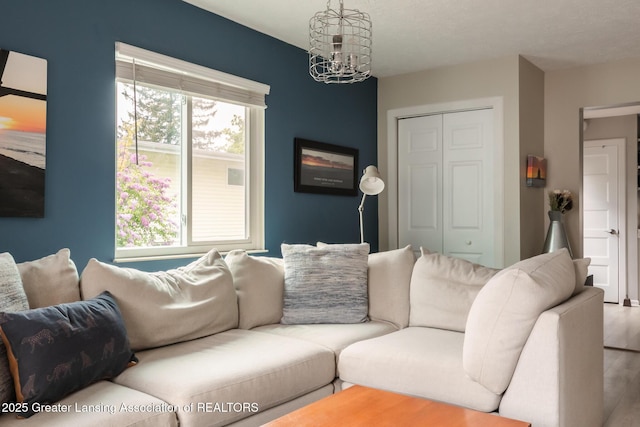 living area with a chandelier and wood finished floors