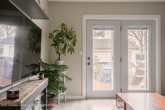 entryway featuring baseboards and light wood-style floors