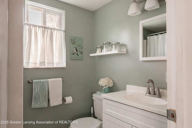 bathroom featuring toilet and vanity