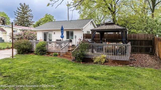 rear view of house with a gazebo and a wooden deck
