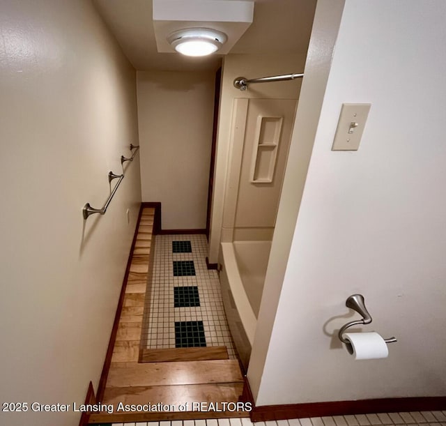 bathroom featuring tile patterned floors, shower / bathtub combination, and baseboards