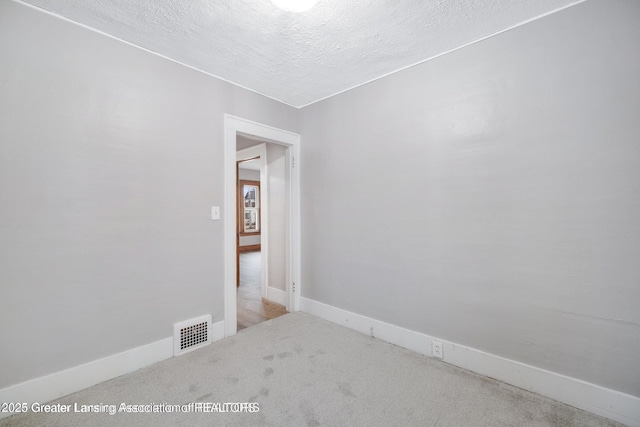 1416 Vermont Ave, Lansing, MI 48906 - carpeted empty room with a textured ceiling and baseboards