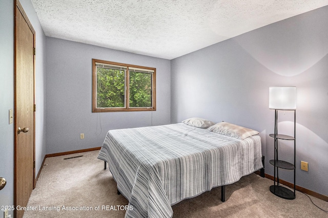 5431 Wild Oak Dr, East Lansing, MI 48823 - carpeted bedroom with baseboards and a textured ceiling