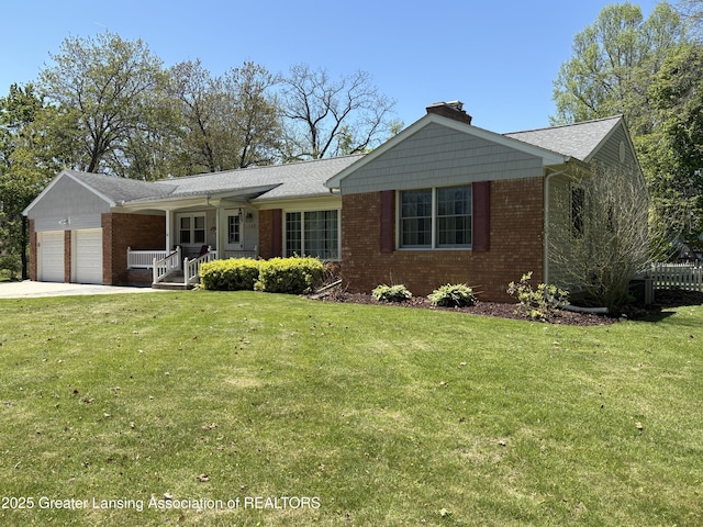 108 S Center St, Eaton Rapids, MI 48827 - single story home with brick siding, an attached garage, a chimney, and covered porch