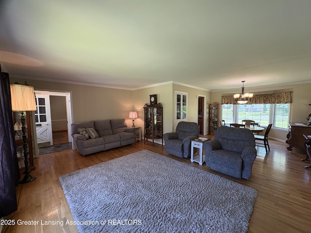 108 S Center St, Eaton Rapids, MI 48827 - living area featuring a chandelier, wood finished floors, and ornamental molding