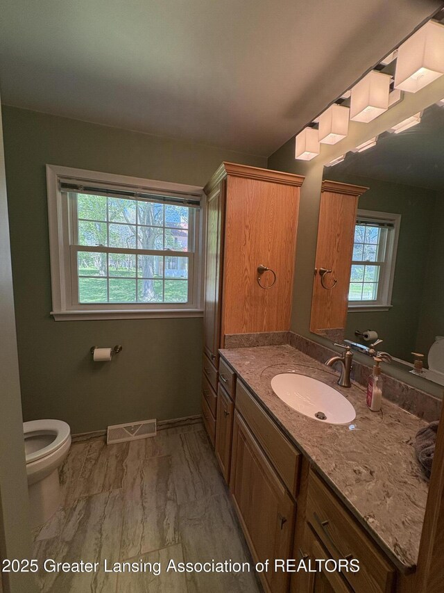 108 S Center St, Eaton Rapids, MI 48827 - bathroom with toilet, vanity, and baseboards