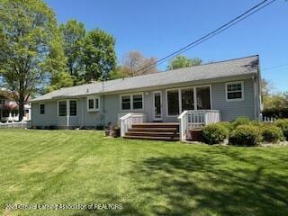 108 S Center St, Eaton Rapids, MI 48827 - rear view of house featuring a lawn