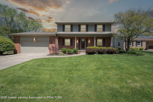 traditional-style home with brick siding, concrete driveway, a garage, a yard, and a porch