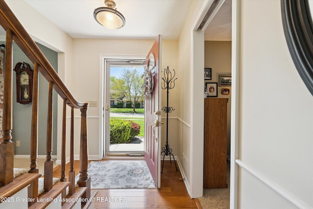 foyer featuring stairs and wood finished floors
