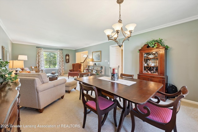 dining room with a chandelier, stairs, light colored carpet, and crown molding