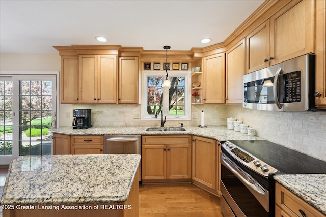 kitchen with stainless steel appliances, a sink, decorative backsplash, light wood-style flooring, and open shelves